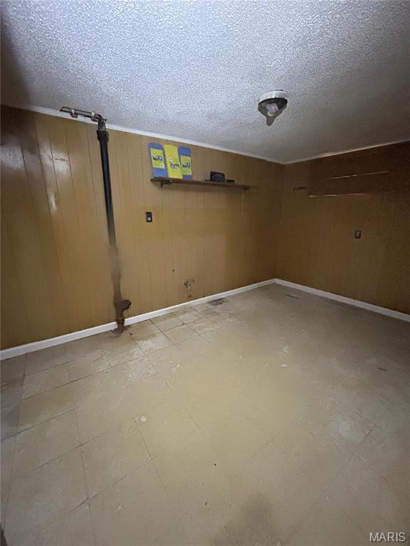 3757 Itaska St, Saint Louis, MO 63116 - finished below grade area with a textured ceiling, wooden walls, and baseboards