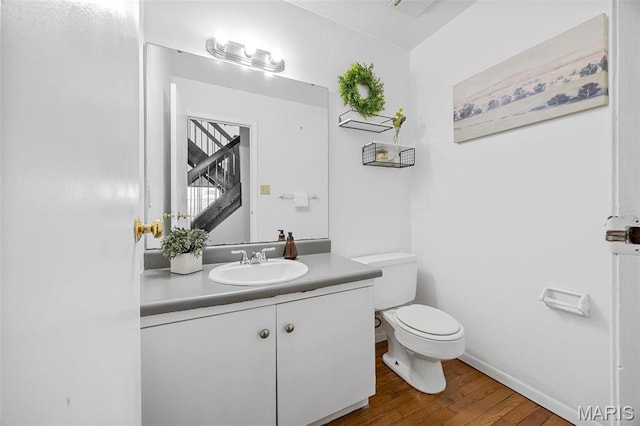 1747 Russet Valley Dr, Saint Louis, MO 63146 - half bathroom with wood finished floors, toilet, vanity, and baseboards