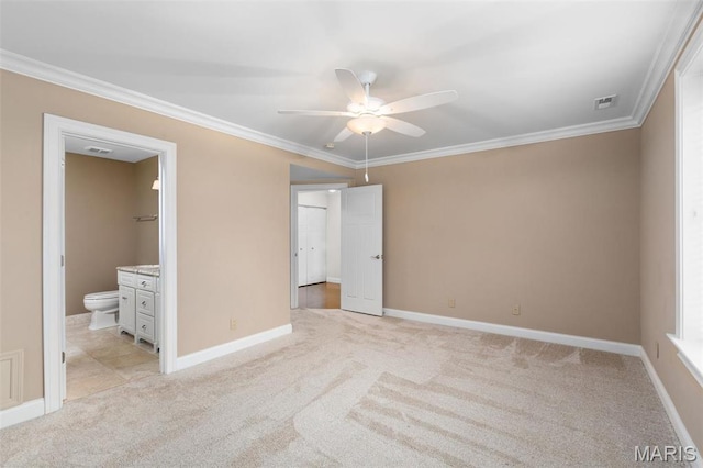 unfurnished bedroom with light carpet, ornamental molding, baseboards, and ensuite bathroom