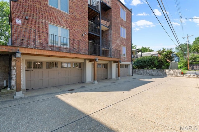 view of property featuring a garage and driveway