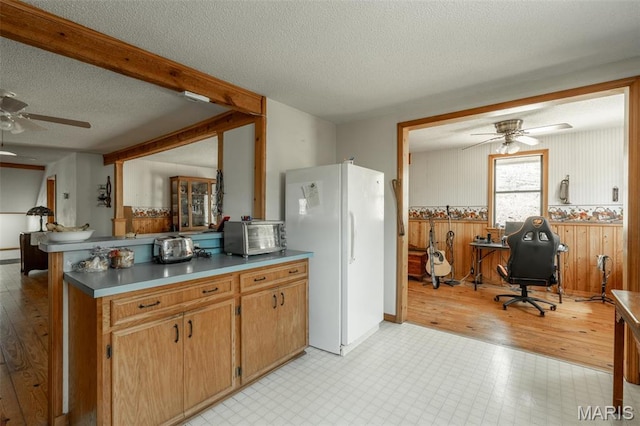 124 Wayne 527, Greenville, MO 63944 - kitchen with a ceiling fan, freestanding refrigerator, a peninsula, a textured ceiling, and a desk