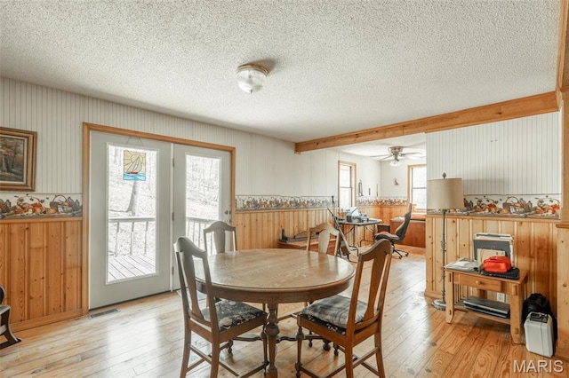124 Wayne 527, Greenville, MO 63944 - dining room featuring light wood-type flooring, wainscoting, a textured ceiling, wood walls, and ceiling fan