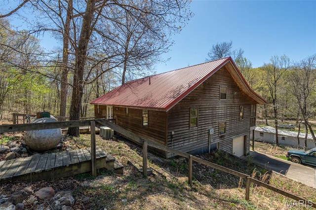 124 Wayne 527, Greenville, MO 63944 - view of property exterior with a wooden deck, central AC, metal roof, and driveway