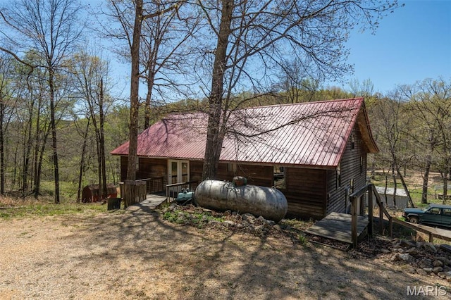 124 Wayne 527, Greenville, MO 63944 - view of side of home with metal roof and a forest view