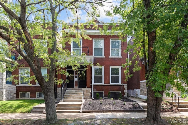 2220 Nebraska Ave, Saint Louis, MO 63104 - view of front facade featuring a balcony, central AC, and brick siding