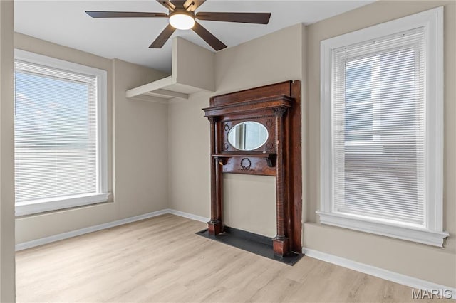 2220 Nebraska Ave, Saint Louis, MO 63104 - unfurnished living room with wood finished floors, a ceiling fan, baseboards, and plenty of natural light
