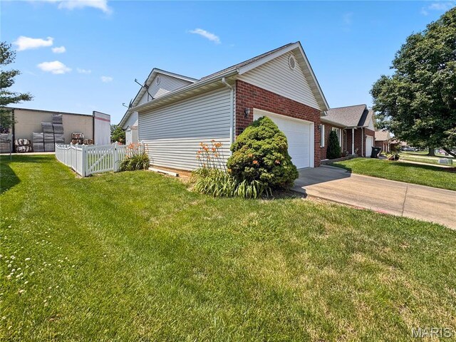 737 Marney Ln, Waterloo, IL 62298 - view of home's exterior with an attached garage, brick siding, and driveway
