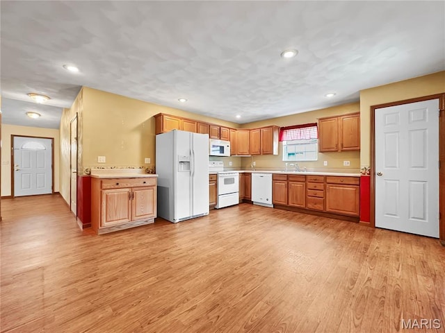 737 Marney Ln, Waterloo, IL 62298 - kitchen with white appliances, light countertops, light wood-style flooring, recessed lighting, and brown cabinetry