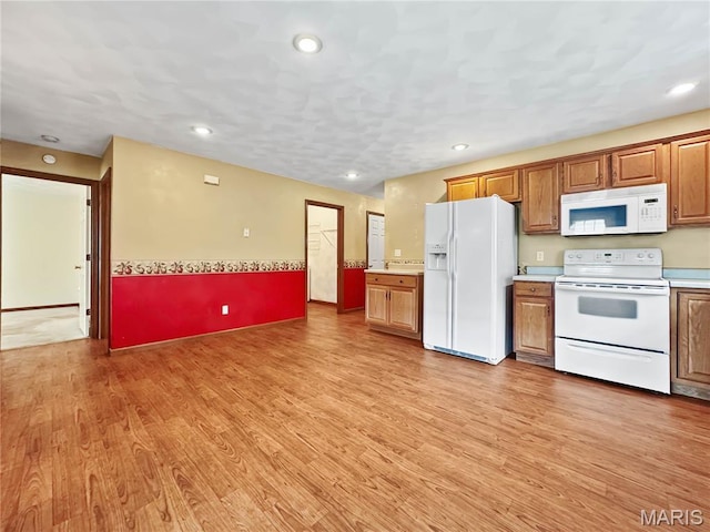 737 Marney Ln, Waterloo, IL 62298 - kitchen with white appliances, light countertops, light wood-style floors, brown cabinets, and recessed lighting