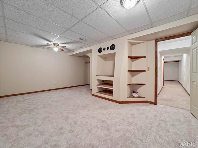 737 Marney Ln, Waterloo, IL 62298 - finished below grade area with light carpet, built in shelves, a drop ceiling, and a ceiling fan