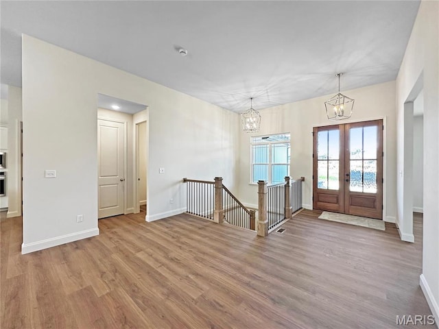 204 Great Bear Pass, Foristell, MO 63348 - foyer with a chandelier, wood finished floors, baseboards, and french doors