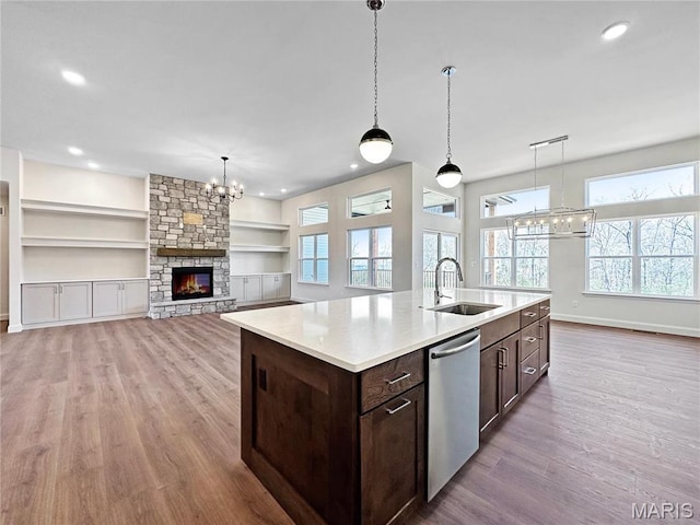 204 Great Bear Pass, Foristell, MO 63348 - kitchen featuring a sink, dishwasher, dark brown cabinetry, light wood-style floors, and a chandelier