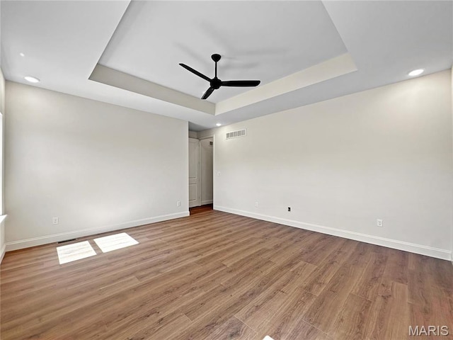 204 Great Bear Pass, Foristell, MO 63348 - unfurnished room with a tray ceiling, ceiling fan, baseboards, wood finished floors, and recessed lighting