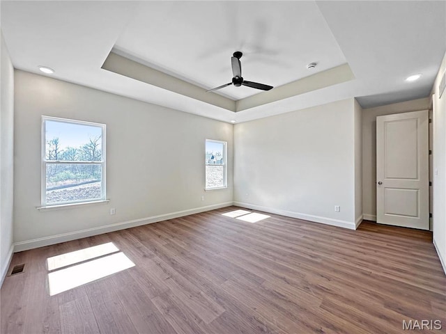 204 Great Bear Pass, Foristell, MO 63348 - spare room featuring a tray ceiling, healthy amount of natural light, baseboards, ceiling fan, and recessed lighting