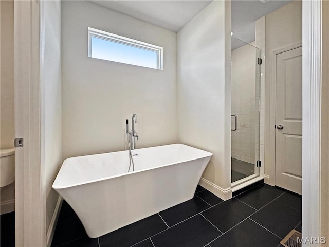 204 Great Bear Pass, Foristell, MO 63348 - bathroom with a stall shower, a soaking tub, toilet, tile patterned flooring, and baseboards