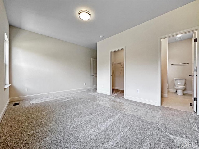 204 Great Bear Pass, Foristell, MO 63348 - unfurnished bedroom with carpet, a walk in closet, baseboards, and a closet