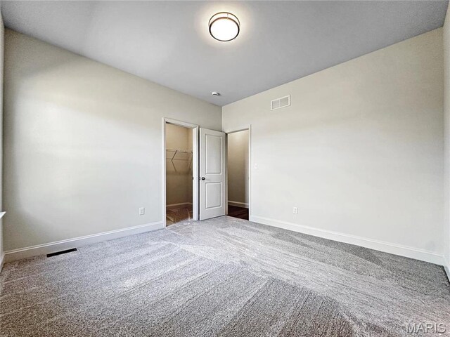 204 Great Bear Pass, Foristell, MO 63348 - unfurnished bedroom with carpet, baseboards, a walk in closet, and a closet