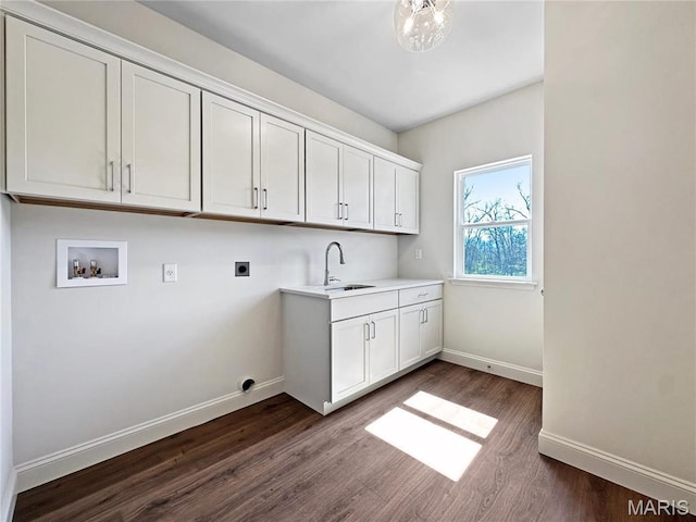 204 Great Bear Pass, Foristell, MO 63348 - washroom featuring hookup for an electric dryer, hookup for a washing machine, dark wood-style flooring, baseboards, and cabinet space
