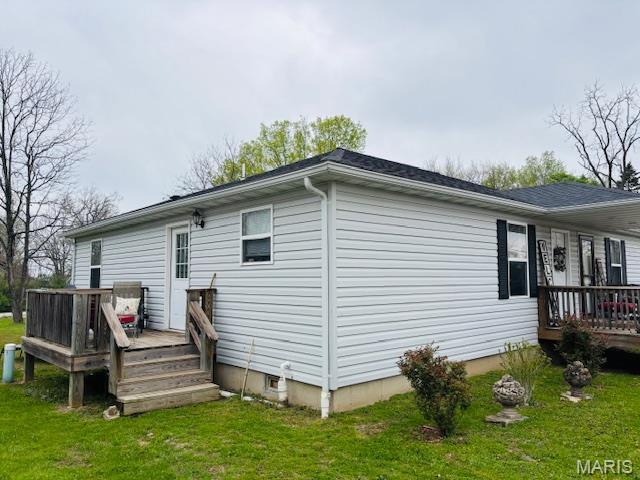 9 Mcleod St Unit A, Cuba, MO 65453 - view of side of property with a wooden deck and a lawn