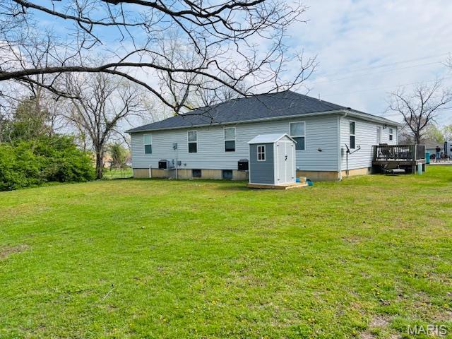9 Mcleod St Unit A, Cuba, MO 65453 - rear view of house featuring a storage unit, a wooden deck, an outbuilding, and a yard