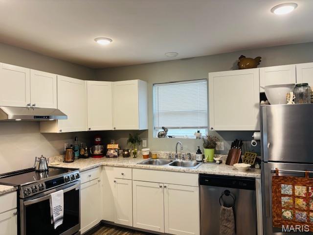 9 Mcleod St Unit A, Cuba, MO 65453 - kitchen featuring stainless steel appliances, a sink, under cabinet range hood, light countertops, and white cabinetry