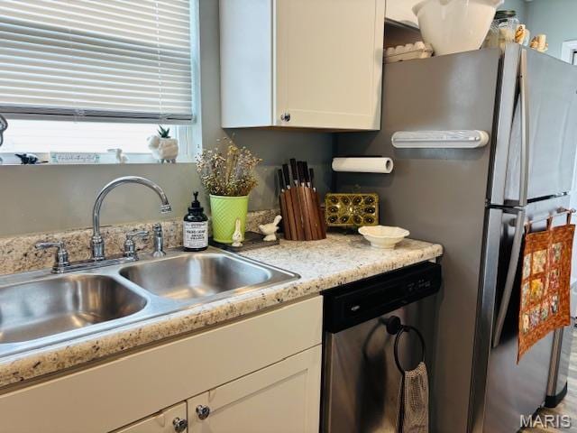 9 Mcleod St Unit A, Cuba, MO 65453 - kitchen with appliances with stainless steel finishes, a sink, white cabinetry, and light countertops