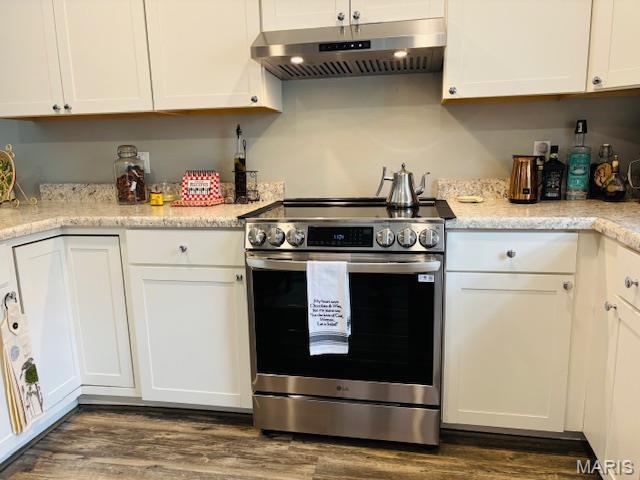 9 Mcleod St Unit A, Cuba, MO 65453 - kitchen with stainless steel range with electric cooktop, under cabinet range hood, white cabinetry, and dark wood-style flooring