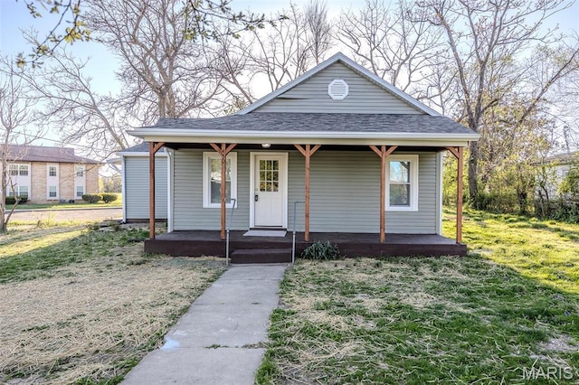 450 Michigan, Lebanon, MO 65536 - view of front of home with covered porch, a front lawn, and roof with shingles