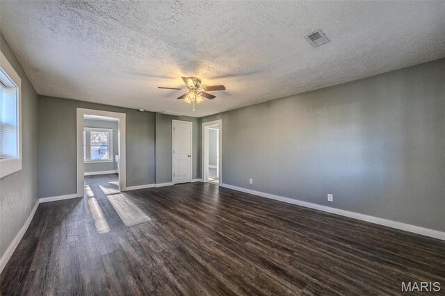 450 Michigan, Lebanon, MO 65536 - unfurnished bedroom with dark wood-style flooring, baseboards, a textured ceiling, and ceiling fan