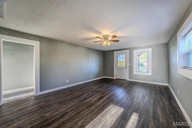 450 Michigan, Lebanon, MO 65536 - spare room featuring dark wood-style flooring, a textured ceiling, ceiling fan, and baseboards