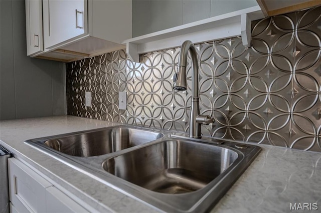 450 Michigan, Lebanon, MO 65536 - kitchen view of a sink, backsplash, pot filler, and white cabinets
