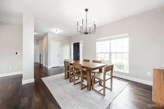 dining room with a chandelier, baseboards, and dark wood finished floors