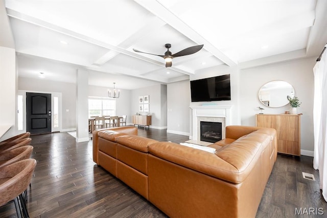 living area featuring baseboards, dark wood-style flooring, ceiling fan, a glass covered fireplace, and coffered ceiling