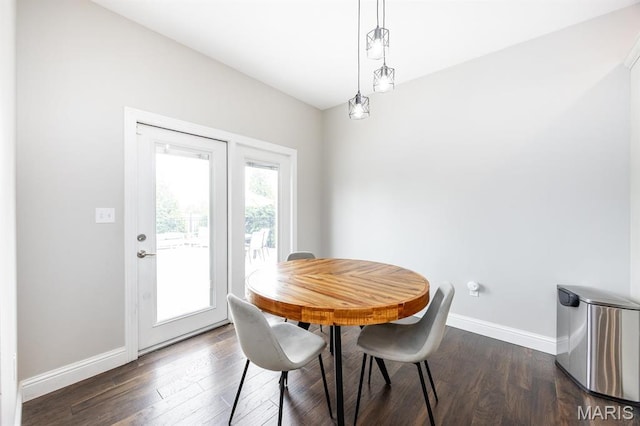 dining space with baseboards and dark wood-style floors