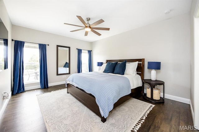bedroom featuring baseboards, wood finished floors, and ceiling fan