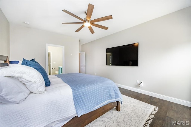 bedroom featuring baseboards, wood finished floors, ceiling fan, and ensuite bath