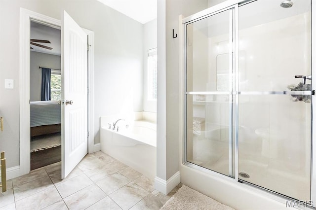 full bathroom with a garden tub, a shower stall, ensuite bathroom, and baseboards