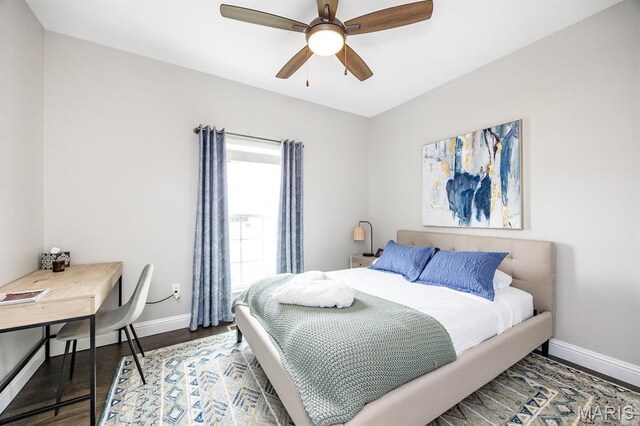 bedroom with baseboards, wood finished floors, and a ceiling fan