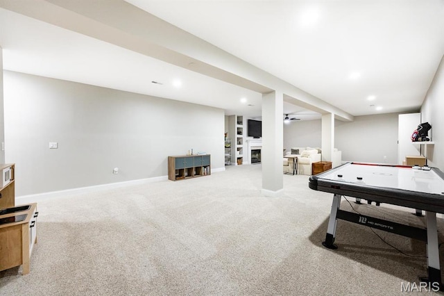 recreation room featuring carpet flooring, baseboards, recessed lighting, and a fireplace