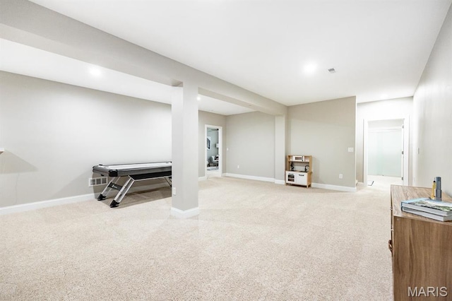 finished below grade area with light carpet and baseboards