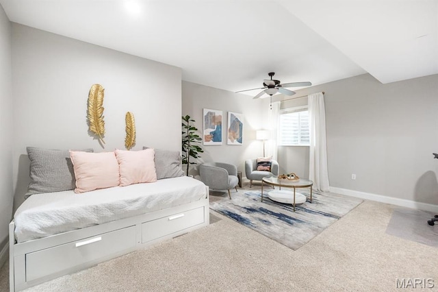 carpeted living room with a ceiling fan and baseboards