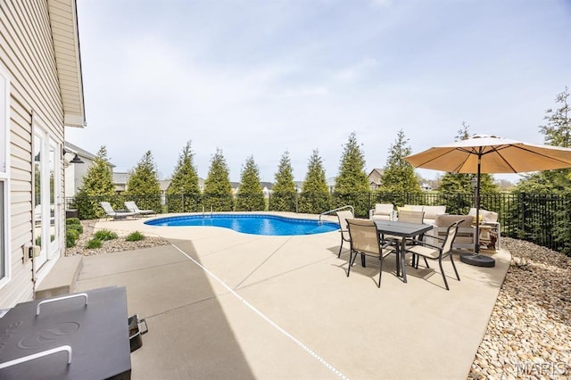 view of pool with a patio, a fenced backyard, and outdoor dining area