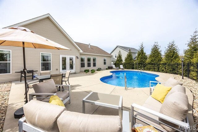 view of swimming pool with a patio, outdoor lounge area, and fence
