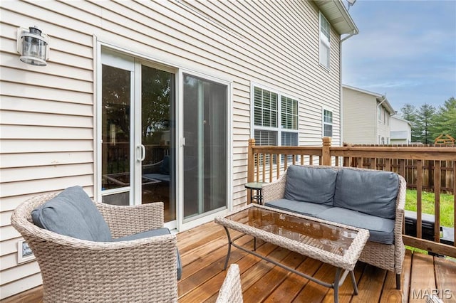 deck featuring an outdoor hangout area and fence