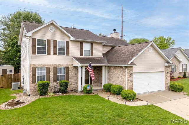 traditional-style house with concrete driveway, a garage, central air condition unit, a shingled roof, and brick siding