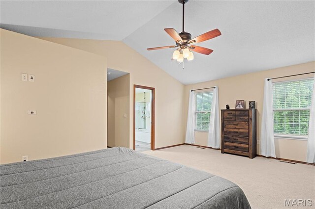 bedroom with lofted ceiling, light carpet, baseboards, and a ceiling fan