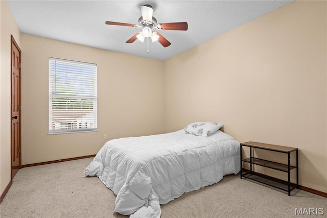 carpeted bedroom with baseboards and ceiling fan