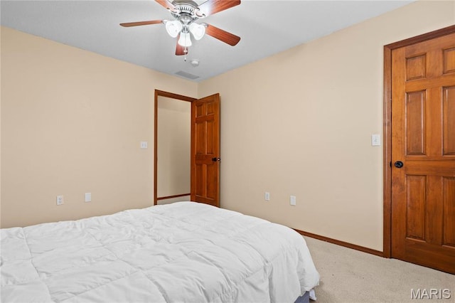 carpeted bedroom with baseboards and a ceiling fan