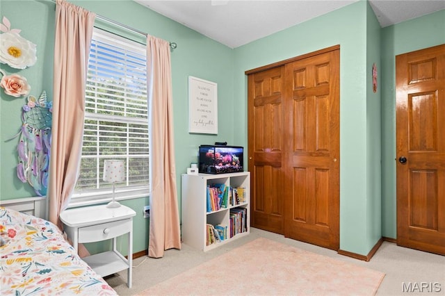 bedroom with carpet flooring, multiple windows, and baseboards
