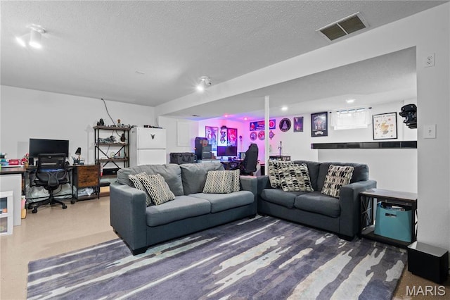 living area featuring an office area and a textured ceiling